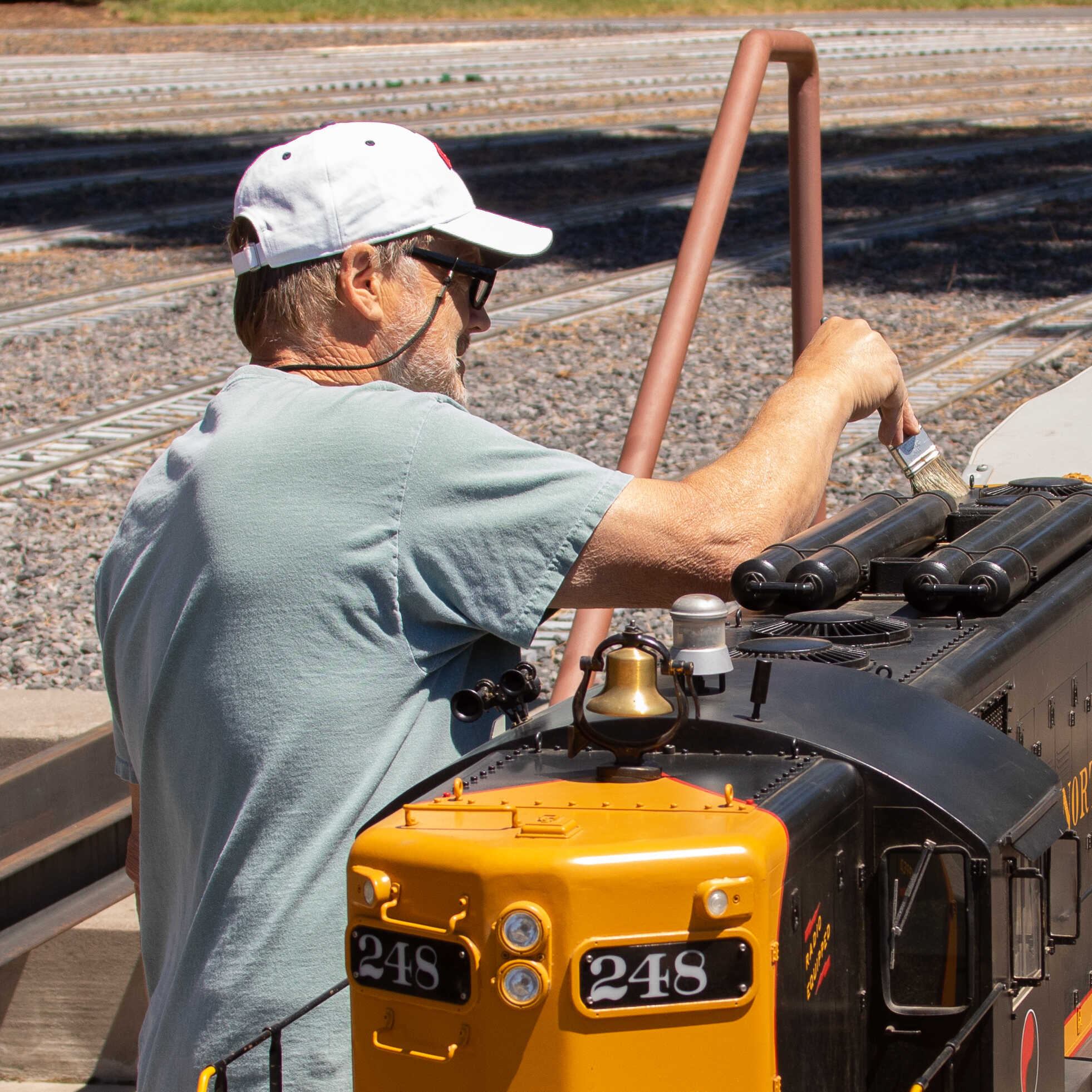 Man painting Northern Pacific locomotive with brush